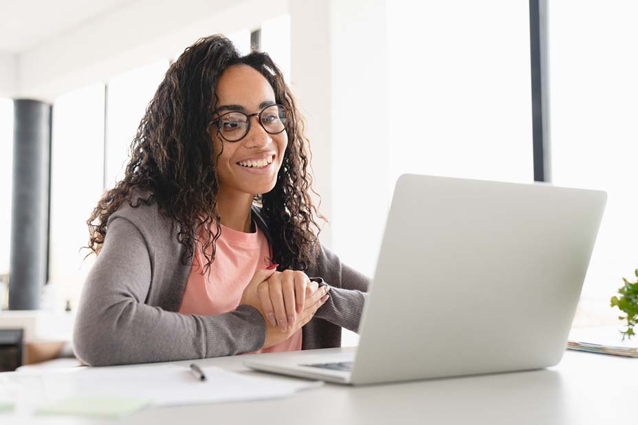 Happy young african student businesswoman freelancer watching video webinars online, having videocall conversation, e-learning, tutoring at home office