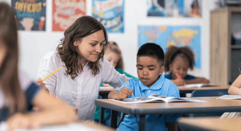 female teacher assisting elementary student