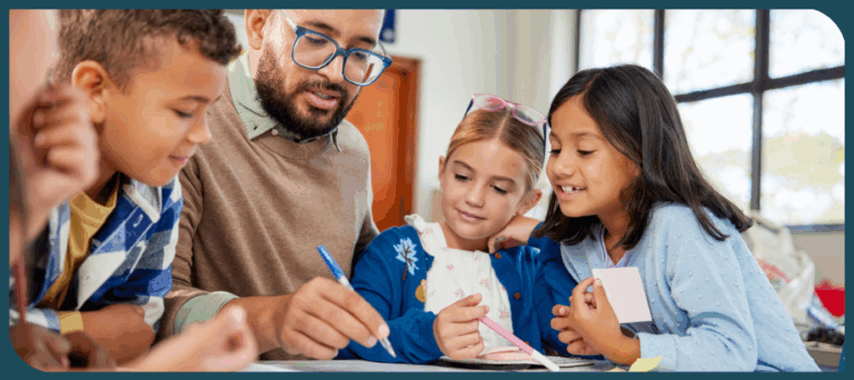 male elementary teacher instructing small group of students